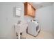 Functional laundry room equipped with modern appliances and storage at 8431 Jeremiah Grove St, Las Vegas, NV 89123