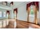 Bright living room with large windows, hardwood floors, and elegant decor, offers a welcoming atmosphere at 8431 Jeremiah Grove St, Las Vegas, NV 89123