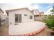 Backyard features a concrete patio and mature trees, creating a tranquil outdoor space with easy access to the home at 8564 Lost Gold Ave, Las Vegas, NV 89129