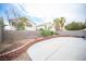 Expansive backyard boasts a concrete patio, bordered by a retaining wall and desert landscaping for easy maintenance at 8564 Lost Gold Ave, Las Vegas, NV 89129