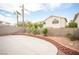 Spacious backyard features a large concrete patio, retaining wall, and desert landscaping for outdoor enjoyment at 8564 Lost Gold Ave, Las Vegas, NV 89129