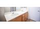 Bathroom featuring double sinks, a large mirror, and wood cabinets at 8564 Lost Gold Ave, Las Vegas, NV 89129