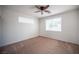 Spacious bedroom with a ceiling fan and two windows providing natural light at 8564 Lost Gold Ave, Las Vegas, NV 89129