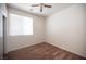 Empty bedroom features neutral carpet, a window with blinds, and a ceiling fan at 8564 Lost Gold Ave, Las Vegas, NV 89129
