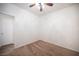 Vacant room features carpet, ceiling fan, and access to wood-style-floored room at 8564 Lost Gold Ave, Las Vegas, NV 89129