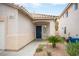Close-up of the front door with a tiled roof overhang, neat landscaping, and charming exterior details at 8564 Lost Gold Ave, Las Vegas, NV 89129