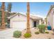 Inviting single-story home with a two-car garage and desert landscaping for a low-maintenance lifestyle at 8564 Lost Gold Ave, Las Vegas, NV 89129