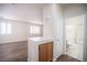 Hallway view with wood-style flooring, cabinet, and a bathroom featuring a shower over the tub at 8564 Lost Gold Ave, Las Vegas, NV 89129