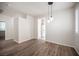 Open living room with wood floors and modern lighting at 8564 Lost Gold Ave, Las Vegas, NV 89129