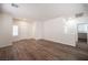 Open-concept living room with stylish wood-look flooring, neutral paint, and ample natural light from shuttered windows at 8564 Lost Gold Ave, Las Vegas, NV 89129