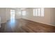 Bright living room with beautiful wood-look flooring and shuttered windows, providing a welcoming and modern space at 8564 Lost Gold Ave, Las Vegas, NV 89129