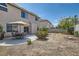 Backyard features a concrete patio with a dining set and a partially xeriscaped yard at 890 Socorro Song Ln, Henderson, NV 89052