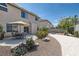 Landscaped backyard features a patio with a dining set, rock features, and a retaining wall at 890 Socorro Song Ln, Henderson, NV 89052