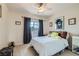 Comfortable bedroom with ceiling fan, window with views, and carpeted floor at 890 Socorro Song Ln, Henderson, NV 89052