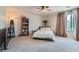 Spacious bedroom featuring a ceiling fan, plush carpeting, and natural light from a large window at 890 Socorro Song Ln, Henderson, NV 89052