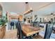 Open-concept dining area with a stylish light fixture and seamless flow to the living room and kitchen at 890 Socorro Song Ln, Henderson, NV 89052