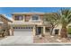 Attractive two-story home with a two-car garage and desert-style landscaping, offering curb appeal and a welcoming entrance at 890 Socorro Song Ln, Henderson, NV 89052