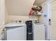 Functional laundry room featuring modern washer and dryer and storage shelves at 890 Socorro Song Ln, Henderson, NV 89052
