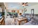 Spacious living room with hardwood floors, comfortable seating, and an open layout with a view to the kitchen at 890 Socorro Song Ln, Henderson, NV 89052
