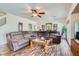 Comfortable living room with hardwood floors, a large sectional sofa, and plenty of natural light at 890 Socorro Song Ln, Henderson, NV 89052