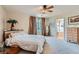 Bright main bedroom features a ceiling fan, closet, and ensuite bathroom at 890 Socorro Song Ln, Henderson, NV 89052