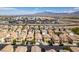 A high-angle shot of a neighborhood with views of shopping centers and mountains in the background at 9476 Milkweed Canyon Ave, Las Vegas, NV 89166