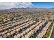 An expansive aerial view reveals a well-planned community and landscape, with desert mountains in the background at 9476 Milkweed Canyon Ave, Las Vegas, NV 89166
