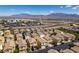 This aerial view shows the neighborhood and surrounding mountain range, with nearby shopping and highway access at 9476 Milkweed Canyon Ave, Las Vegas, NV 89166