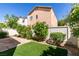 Landscaped backyard featuring artificial turf, stone pathway, and privacy fencing at 9476 Milkweed Canyon Ave, Las Vegas, NV 89166