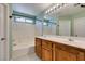 Bathroom featuring a double sink vanity and a shower over bath at 9476 Milkweed Canyon Ave, Las Vegas, NV 89166
