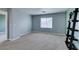 A simple bedroom features gray walls, carpet, and window letting in plenty of natural light at 9476 Milkweed Canyon Ave, Las Vegas, NV 89166