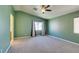 Spacious bedroom featuring a vaulted ceiling, a ceiling fan, and two large windows at 9476 Milkweed Canyon Ave, Las Vegas, NV 89166