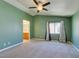 Spacious bedroom featuring a vaulted ceiling, a ceiling fan, and large windows at 9476 Milkweed Canyon Ave, Las Vegas, NV 89166
