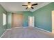 Spacious bedroom featuring a ceiling fan and a large window at 9476 Milkweed Canyon Ave, Las Vegas, NV 89166