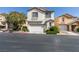 Two-story home with attached garage, neutral tones, and manicured landscaping in residential neighborhood at 9476 Milkweed Canyon Ave, Las Vegas, NV 89166