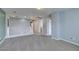 A well-lit hallway features a white staircase and gray walls at 9476 Milkweed Canyon Ave, Las Vegas, NV 89166