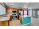 Bright kitchen with stainless appliances, wooden cabinets, island, and tiled backsplash at 9476 Milkweed Canyon Ave, Las Vegas, NV 89166