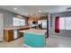 Bright kitchen with stainless appliances, wooden cabinets, kitchen island, and tiled backsplash at 9476 Milkweed Canyon Ave, Las Vegas, NV 89166