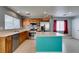 Bright kitchen featuring stainless appliances, wooden cabinets, an island, and tiled backsplash at 9476 Milkweed Canyon Ave, Las Vegas, NV 89166