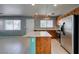 Bright kitchen features stainless appliances, wooden cabinets, tiled backsplash, and center kitchen island at 9476 Milkweed Canyon Ave, Las Vegas, NV 89166