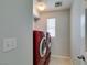 Laundry room with a modern, red, front-load washer and dryer set at 9476 Milkweed Canyon Ave, Las Vegas, NV 89166