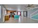 Living room featuring tile floors, a ceiling fan, kitchen with island, and staircase at 9476 Milkweed Canyon Ave, Las Vegas, NV 89166