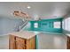 Open floor plan featuring kitchen with island flowing into living room and staircase at 9476 Milkweed Canyon Ave, Las Vegas, NV 89166