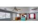 Bright living room featuring tile floors, a ceiling fan, an island, and stainless steel appliances at 9476 Milkweed Canyon Ave, Las Vegas, NV 89166