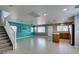 Spacious living room with tile flooring, open layout, and stairs to second floor at 9476 Milkweed Canyon Ave, Las Vegas, NV 89166