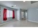 Bright open-concept living area featuring tile flooring, with white doors, and ample natural light at 9476 Milkweed Canyon Ave, Las Vegas, NV 89166