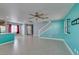 Living room featuring tile floors, a ceiling fan, colorful walls, and staircase at 9476 Milkweed Canyon Ave, Las Vegas, NV 89166