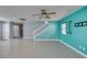 Living room featuring tile floors, a ceiling fan, colorful walls, and staircase at 9476 Milkweed Canyon Ave, Las Vegas, NV 89166