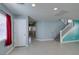Bright open-concept living area featuring tile flooring, and stairs to second floor at 9476 Milkweed Canyon Ave, Las Vegas, NV 89166