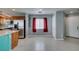 Bright open-concept living area featuring tile flooring, kitchen island, and stainless steel appliances at 9476 Milkweed Canyon Ave, Las Vegas, NV 89166